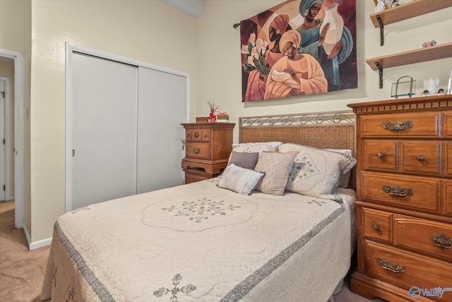 bedroom featuring a closet and light carpet