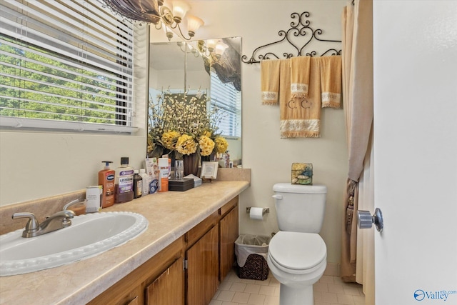 bathroom featuring toilet, vanity, and tile patterned floors