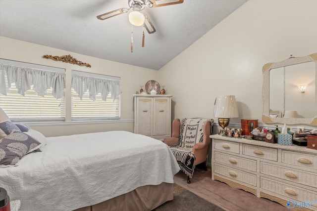 carpeted bedroom with vaulted ceiling, a textured ceiling, and ceiling fan