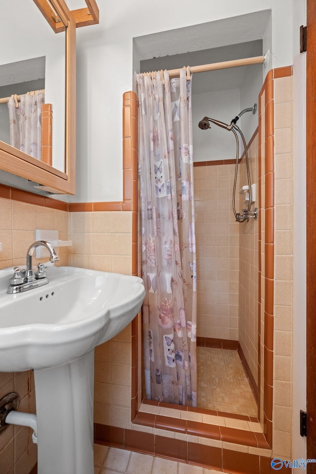 4109 Coffee Cir SW, Huntsville, AL 35805 - full bathroom featuring tile walls, a shower stall, wainscoting, and tile patterned floors