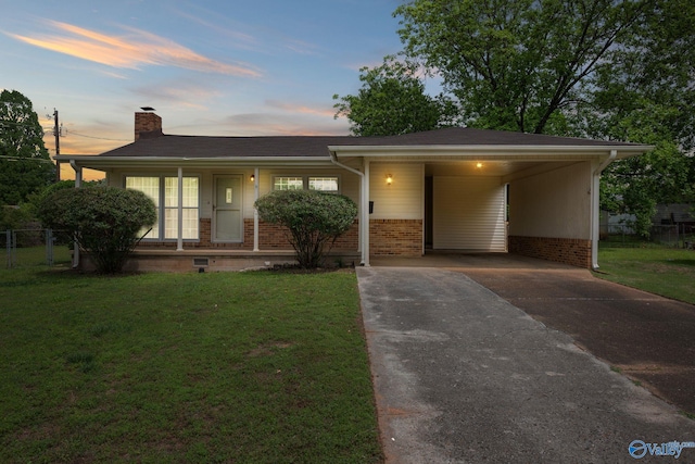 4109 Coffee Cir SW, Huntsville, AL 35805 - view of front of home featuring concrete driveway, a chimney, covered porch, an attached carport, and brick siding