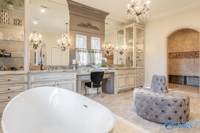 bathroom featuring tile patterned floors, crown molding, vanity, and an inviting chandelier