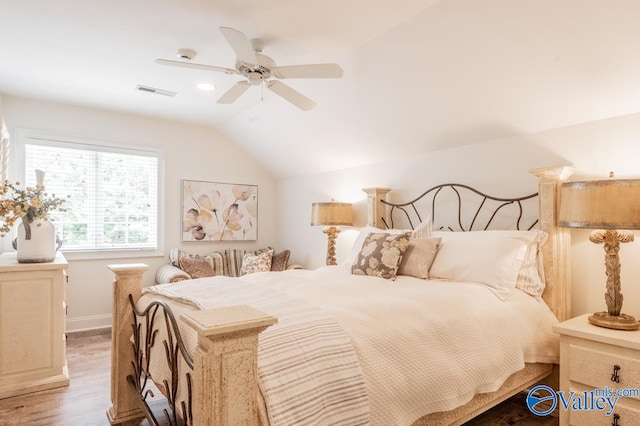 bedroom with light hardwood / wood-style flooring, ceiling fan, and vaulted ceiling