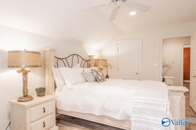 bedroom with ceiling fan, lofted ceiling, and hardwood / wood-style floors