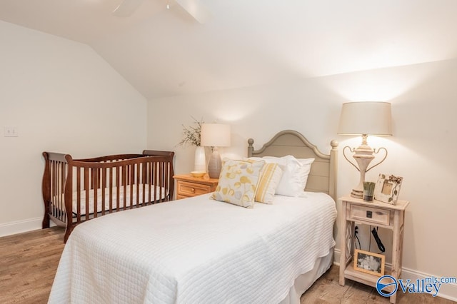 bedroom with lofted ceiling, light hardwood / wood-style floors, and ceiling fan