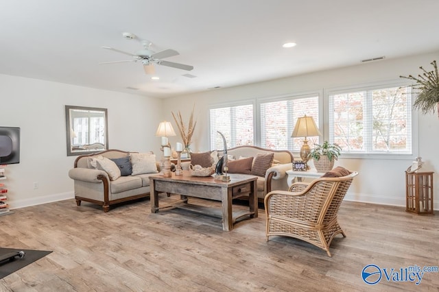 living room with light hardwood / wood-style floors and ceiling fan