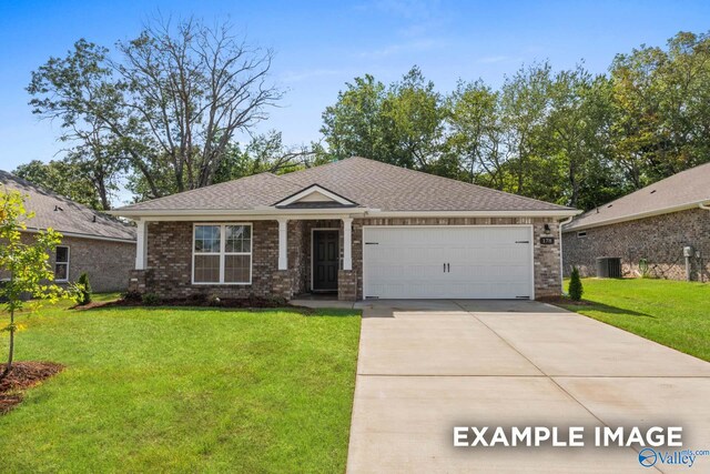 view of front of house with central AC unit, a garage, and a front lawn