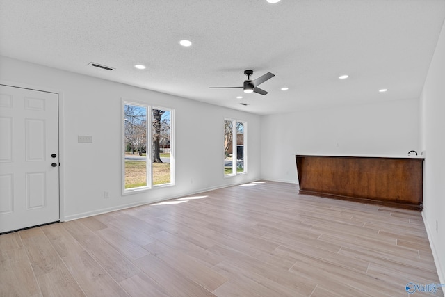 unfurnished living room featuring recessed lighting, visible vents, ceiling fan, and light wood-style floors