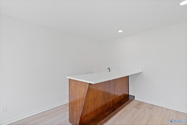 bar with recessed lighting, light wood-type flooring, and baseboards