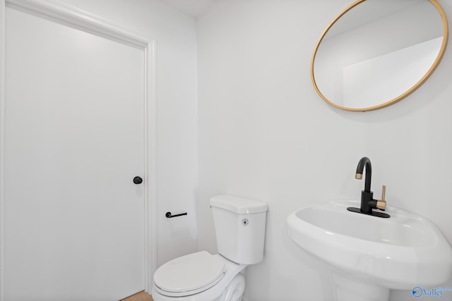 bathroom with toilet and a sink