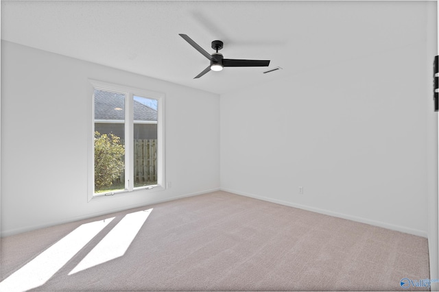 spare room with plenty of natural light and carpet