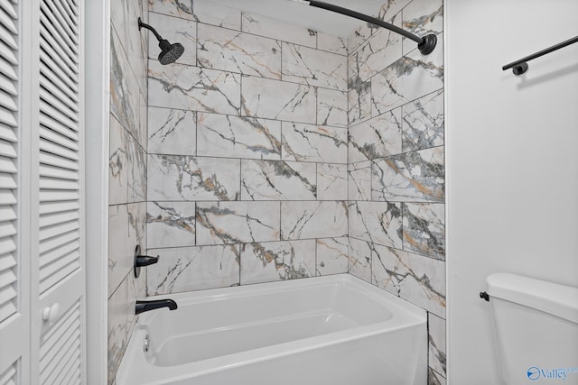 bathroom featuring a closet, toilet, and shower / bathing tub combination