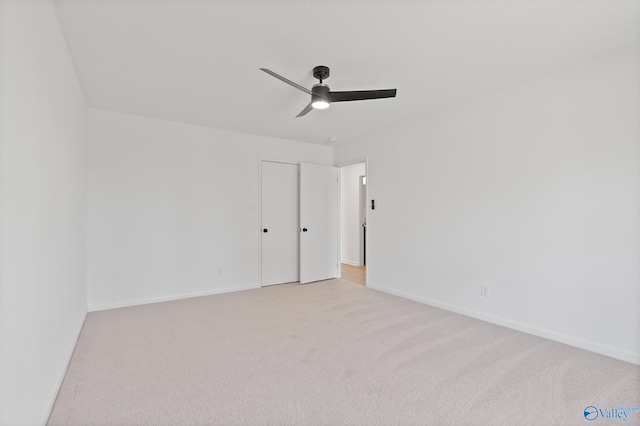 unfurnished bedroom with a ceiling fan, baseboards, and carpet floors