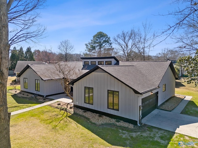 exterior space featuring a yard, a shingled roof, concrete driveway, a garage, and board and batten siding