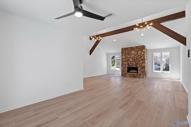 unfurnished living room with baseboards, visible vents, vaulted ceiling with beams, ceiling fan with notable chandelier, and light wood-type flooring