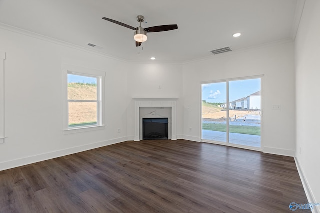 unfurnished living room featuring ceiling fan, a fireplace, crown molding, and dark hardwood / wood-style flooring