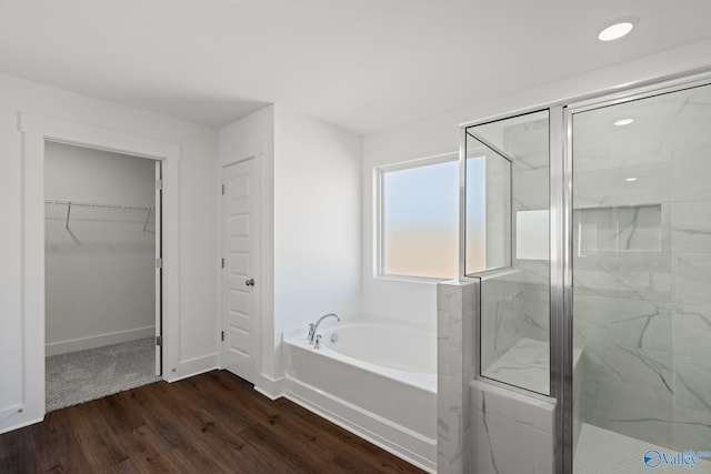 bathroom with shower with separate bathtub and hardwood / wood-style flooring