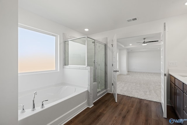 bathroom with independent shower and bath, vanity, hardwood / wood-style floors, and ceiling fan