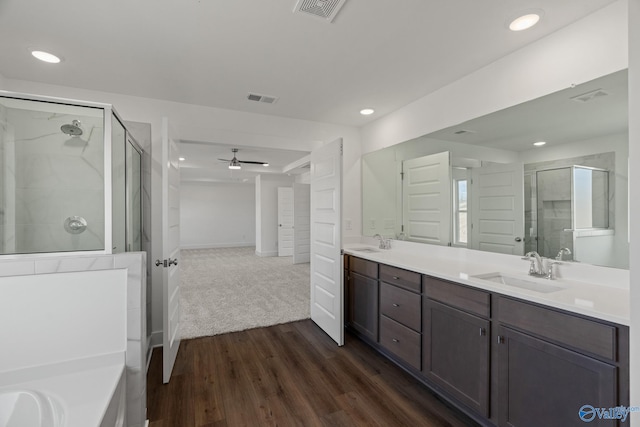 bathroom with vanity, ceiling fan, wood-type flooring, and an enclosed shower