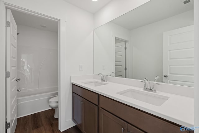 full bathroom featuring bathtub / shower combination, hardwood / wood-style floors, vanity, and toilet