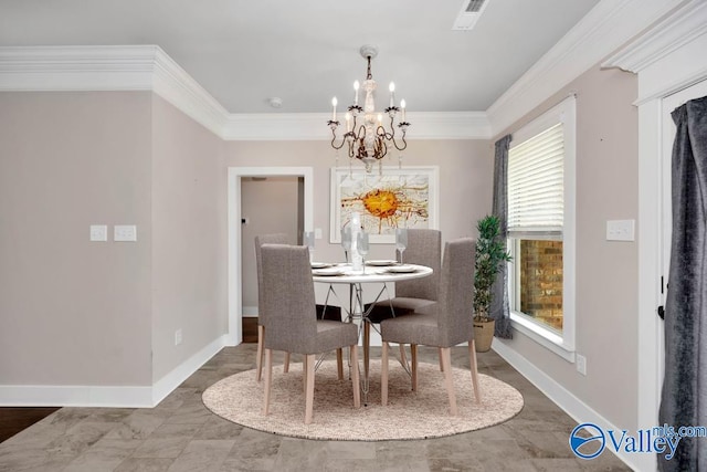 dining space featuring ornamental molding and an inviting chandelier