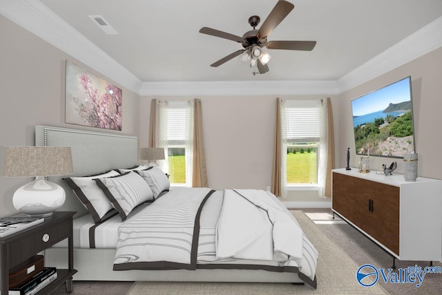 carpeted bedroom with ceiling fan and ornamental molding