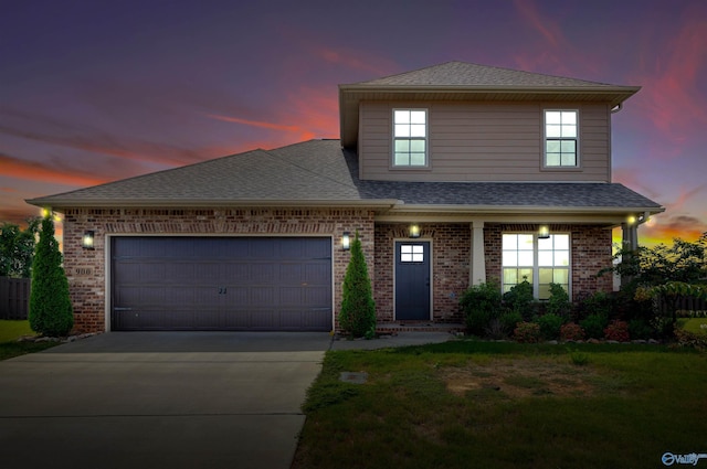 view of front of house featuring a garage and a yard