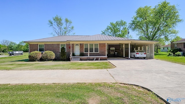 1411 W Washington St, Athens, AL 35611 - single story home with a carport, driveway, brick siding, and a front yard
