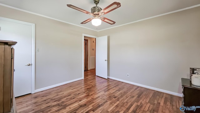 1411 W Washington St, Athens, AL 35611 - unfurnished bedroom featuring baseboards, visible vents, ornamental molding, and wood finished floors