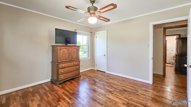 1411 W Washington St, Athens, AL 35611 - unfurnished bedroom featuring baseboards, ornamental molding, ceiling fan, and wood finished floors