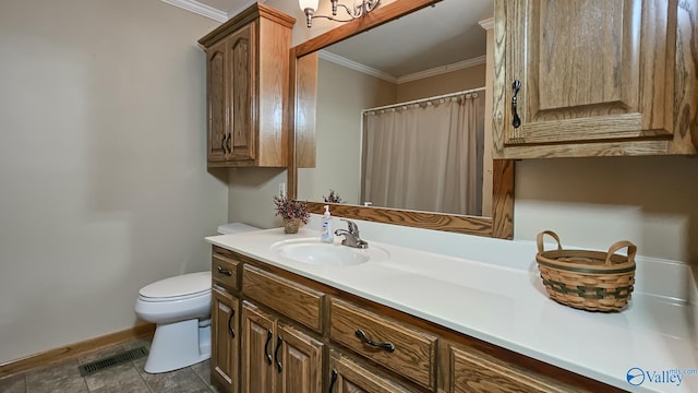1411 W Washington St, Athens, AL 35611 - full bathroom with vanity, toilet, baseboards, visible vents, and ornamental molding