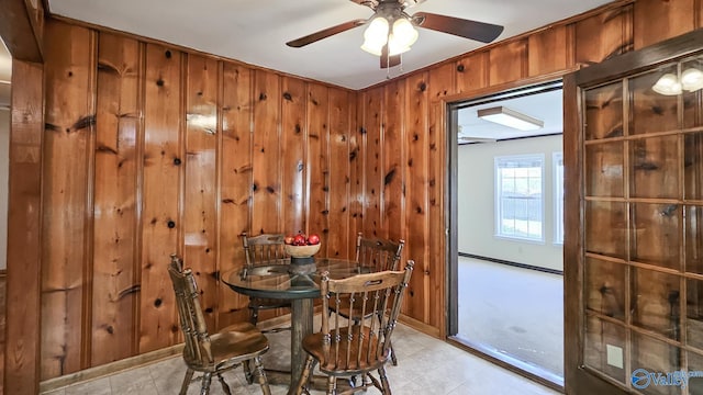 1411 W Washington St, Athens, AL 35611 - dining space with baseboards, wood walls, and a ceiling fan