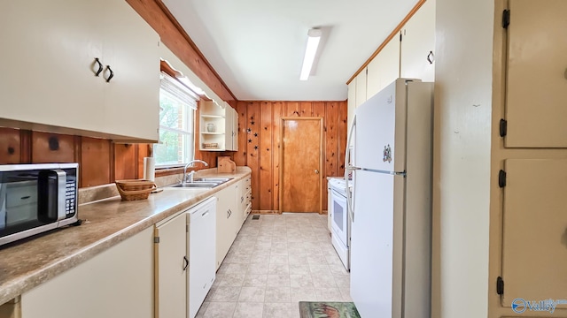 1411 W Washington St, Athens, AL 35611 - kitchen with wood walls, a sink, light countertops, white cabinets, and white appliances