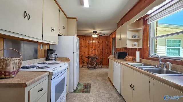 1411 W Washington St, Athens, AL 35611 - kitchen with ceiling fan, a sink, wooden walls, white appliances, and white cabinetry