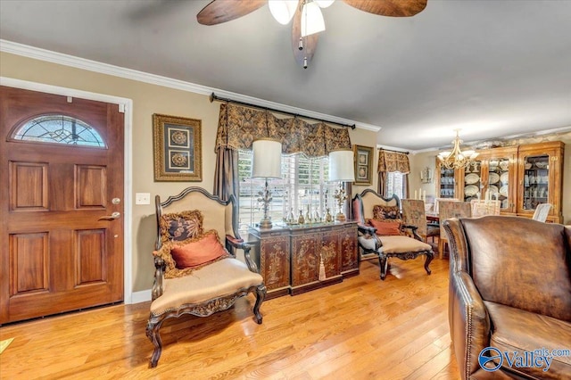 entryway with light hardwood / wood-style flooring, ceiling fan with notable chandelier, and crown molding