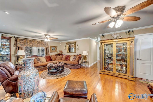 living room featuring ornamental molding, light hardwood / wood-style flooring, and ceiling fan