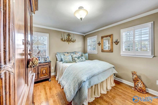 bedroom with light hardwood / wood-style floors and crown molding