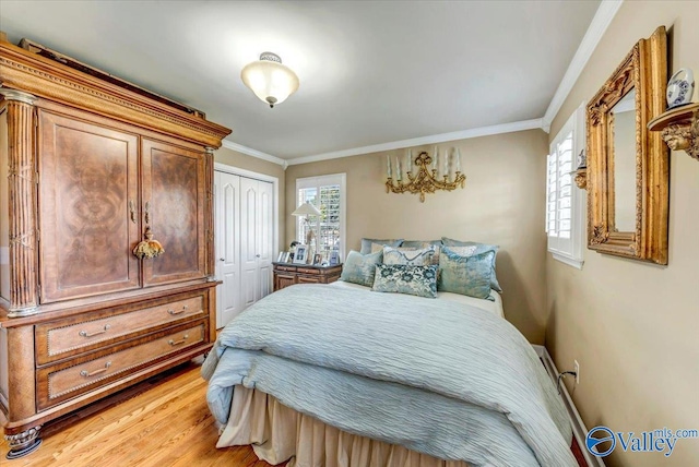 bedroom with light hardwood / wood-style floors, a closet, and crown molding