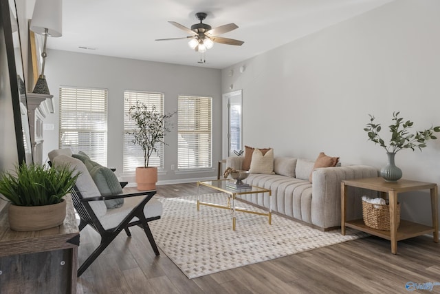 living room featuring wood-type flooring and ceiling fan