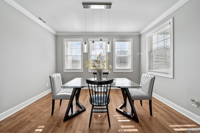 dining space featuring crown molding and a wealth of natural light