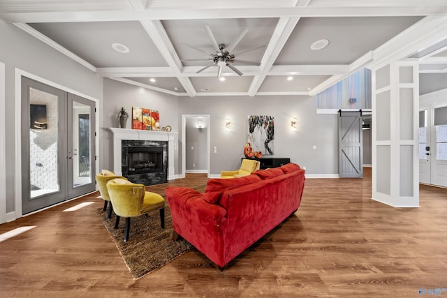 living room featuring french doors, coffered ceiling, ceiling fan, a barn door, and beam ceiling