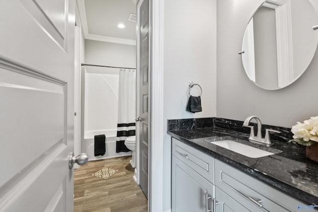 full bathroom featuring hardwood / wood-style floors, vanity, crown molding, toilet, and shower / tub combo with curtain