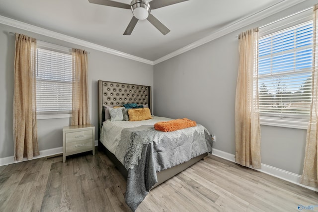 bedroom with hardwood / wood-style floors, ceiling fan, ornamental molding, and multiple windows