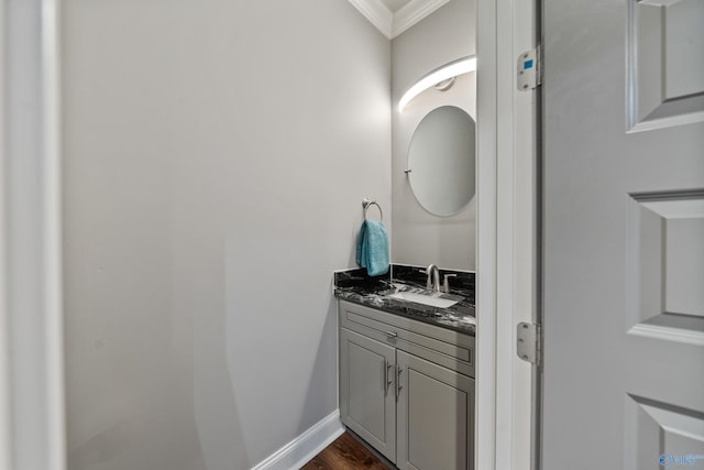 bathroom featuring vanity, hardwood / wood-style flooring, and crown molding