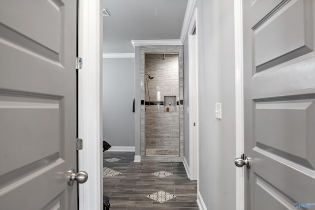 interior space with tiled shower and crown molding