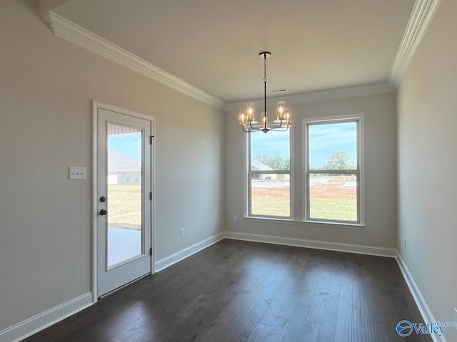 unfurnished dining area featuring crown molding, dark hardwood / wood-style floors, and a chandelier