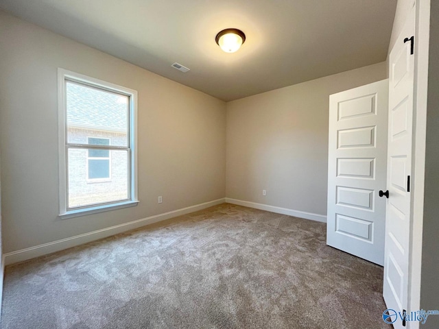 empty room featuring light colored carpet