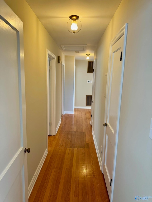 hall with wood-type flooring