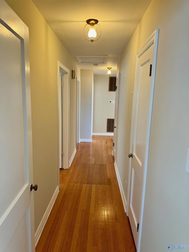 514 Marsheutz Ave SW, Huntsville, AL 35801 - hall with wood-type flooring, baseboards, attic access, and visible vents