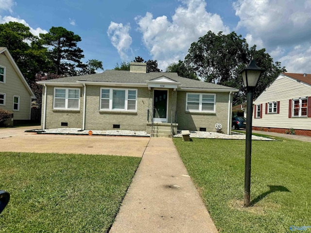 bungalow-style home with a front yard